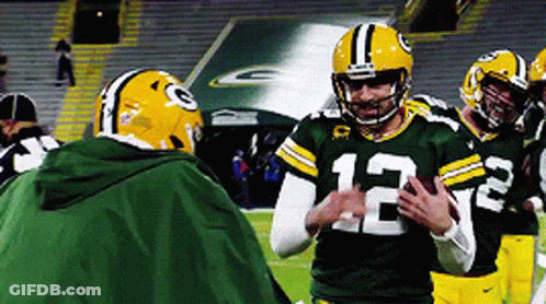 Football Player Number 12 Talking To Another Player GIF