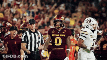 Football Player Number 14 Surrounded By Players GIF