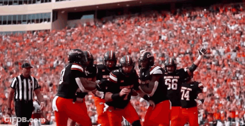 Football Player Number 14 Surrounded By Players GIF
