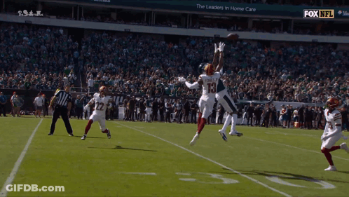 Football Player Number 15 Jumping To Catch Ball GIF