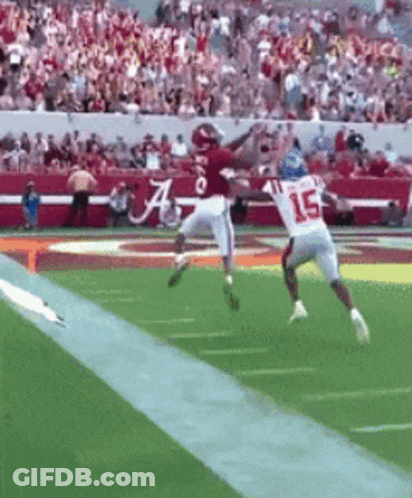 Football Player Number 15 Jumping To Catch Ball GIF