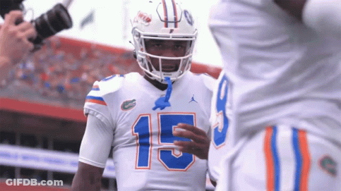 Football Player Number 15 Talks To Another Player GIF