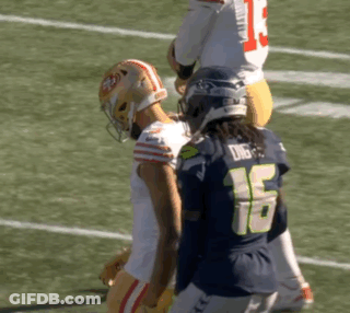 Football Player Number 16 Standing Next To Player GIF