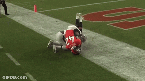 Football Player Number 18 Kneeling On Field GIF
