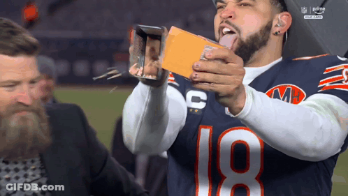 Football Player Number 18 Taking Picture With Phone GIF