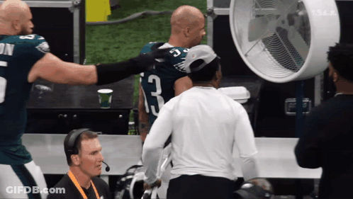 Football Player Number 23 Talking To Another Player GIF