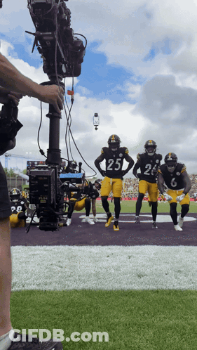 Football Player Number 25 Being Filmed GIF