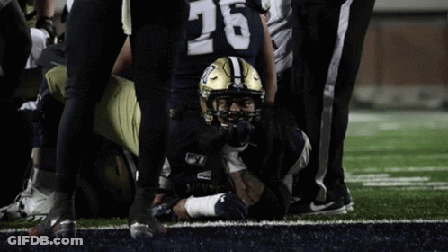 Football Player Number 26 Laying On Field GIF