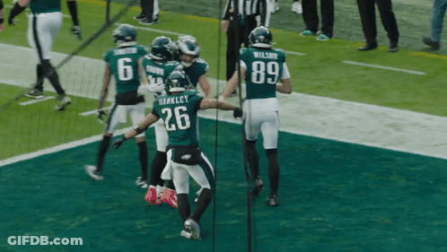 Football Player Number 26 Surrounded By Players GIF