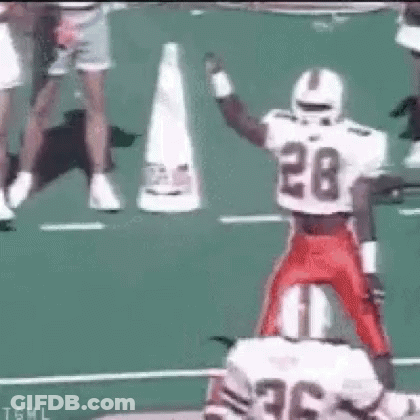 Football Player Number 28 Jumping Over Another Player GIF