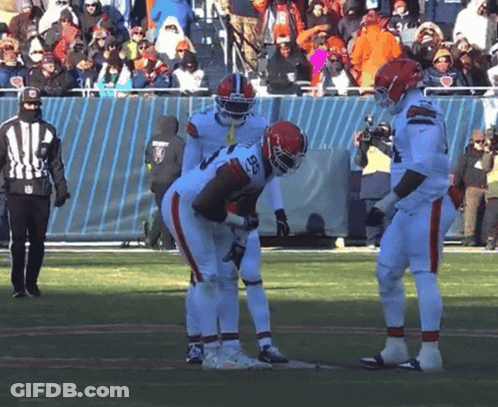Football Player Number 28 Talking To Another Player GIF