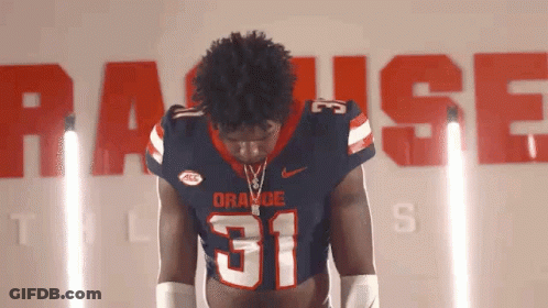 Football Player Number 31 In Front Of Wall Saying Raise GIF