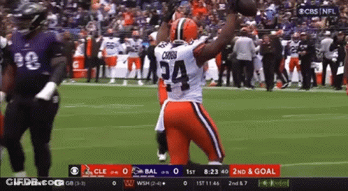 Football Player Number 34 Holding Football In Air GIF