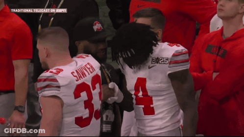 Football Player Number 34 Talking To Another Player GIF