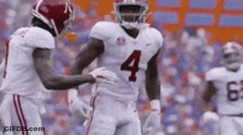 Football Player Number 4 Being Helped By Teammate GIF
