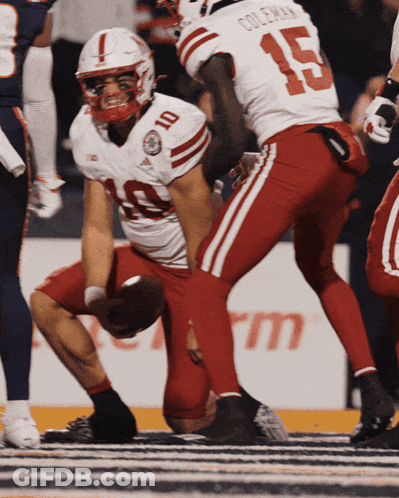 Football Player Number 4 Being Helped By Teammate GIF