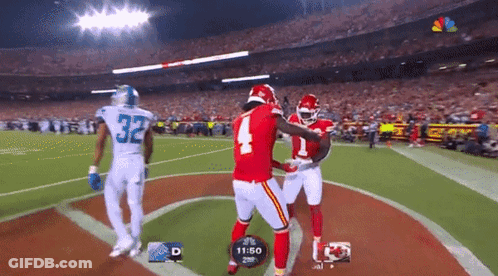 Football Player Number 4 Hugging Another GIF