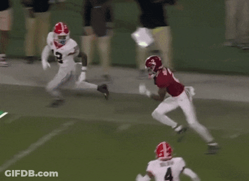 Football Player Number 4 Runs Past Red Jersey GIF