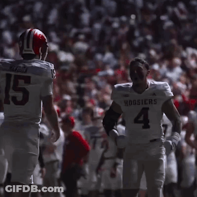 Football Player Number 4 Talking To Another Player GIF