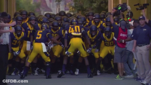 Football Player Number 5 Surrounded By Players GIF