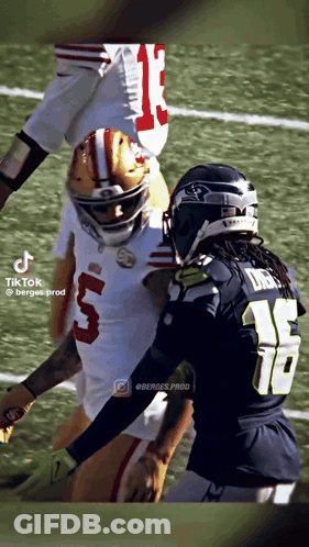 Football Player Number 5 Tackled GIF