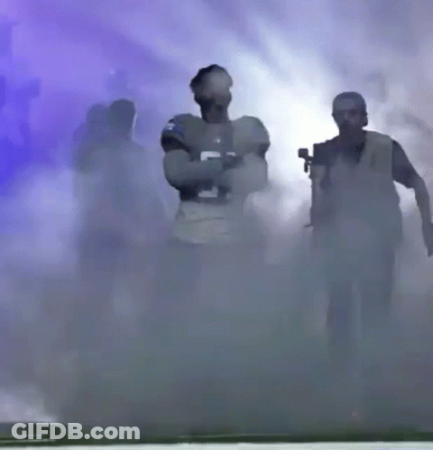 Football Player Number 5 Walking Through Smoke GIF