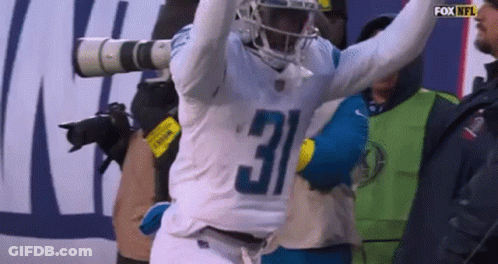 Football Player Number 5 Walking Through Smoke GIF