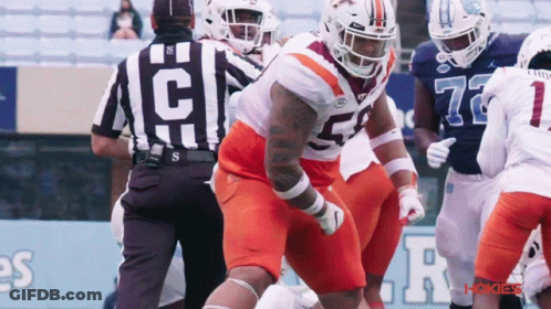 Football Player Number 52 Next To Referee GIF