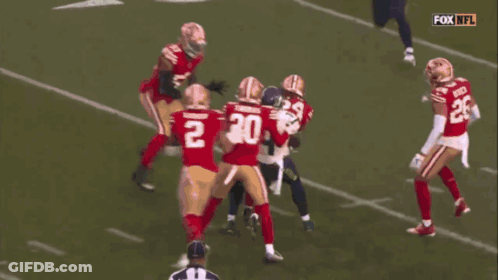 Football Player Number 54 Tackled GIF