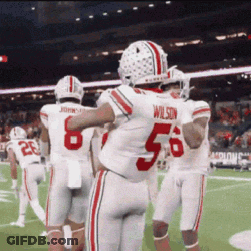 Football Player Number 56 Hugging Teammates GIF