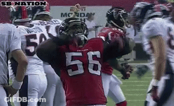Football Player Number 56 Surrounded By Players GIF