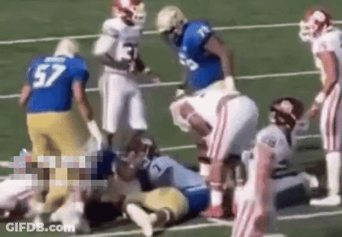 Football Player Number 57 Laying On Field GIF