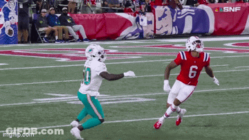 Football Player Number 6 Running Toward Another Player GIF