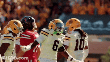 Football Player Number 6 Surrounded By Players GIF