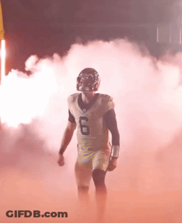 Football Player Number 6 Walking Through Smoke GIF