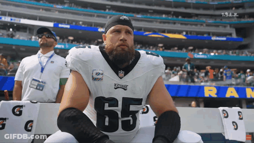 Football Player Number 65 Sitting On Bench GIF