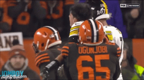 Football Player Number 65 Talking To Another GIF