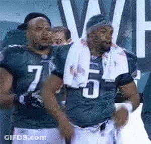 Football Player Number 7 Standing Next To Number 5 GIF