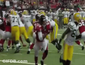Football Player Number 7 Surrounded By Players GIF