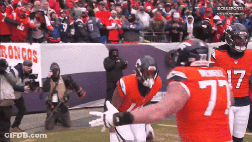 Football Player Number 77 Hugged By Another Player GIF