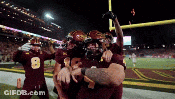 Football Player Number 8 Hugged By Teammates GIF