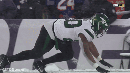 Football Player Number 8 Running In Snow GIF