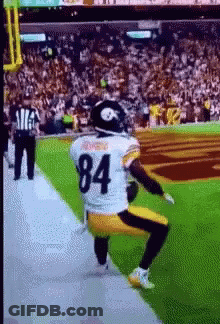 Football Player Number 84 Squatting On Field GIF