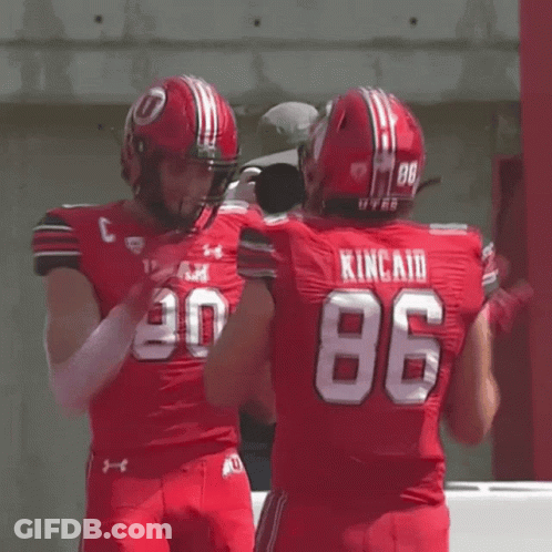 Football Player Number 86 Hugging Another Player GIF