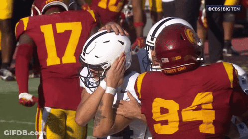 Football Player Number 94 Hugging Another Player GIF