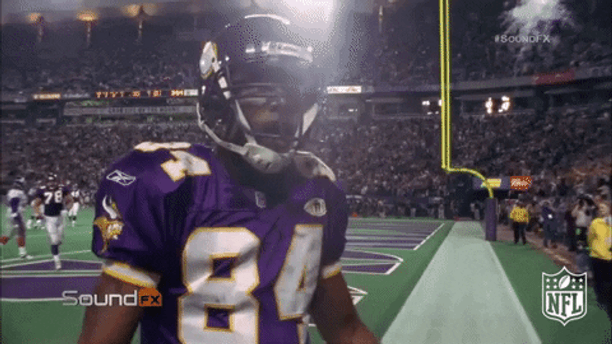 Football Player Randy Moss Showing Off Muscles GIF