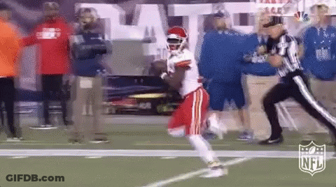 Football Player Running As Referee Looks On GIF