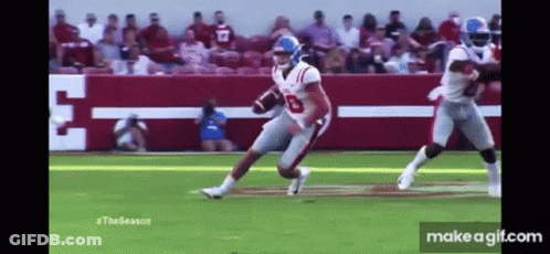 Football Player Running Ball With Tackler GIF