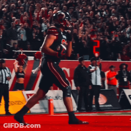 Football Player Running In Front Of Boston Sign GIF