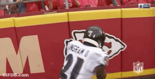 Football Player Running In Front Of NFL Logo Wall GIF